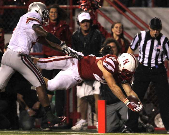 Rex Burkhead dives for the go-head touchdown on a 17-yard run. The TD came 2½ minutes after his 30-yard catch and run had tied the score.